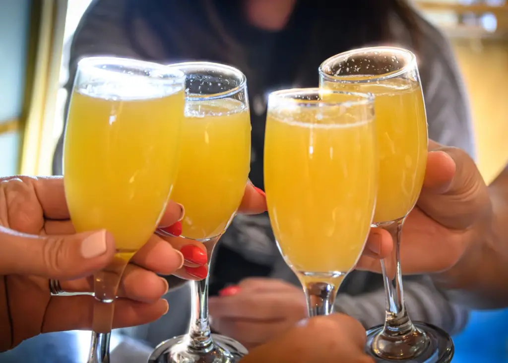 Four glasses of mimosas