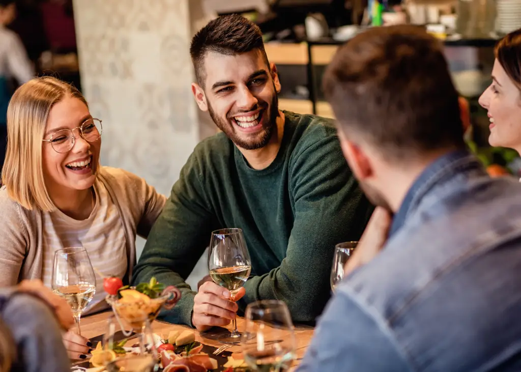 Young group of friends enjoying meal